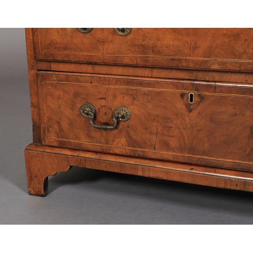 634 - A GEORGE III WALNUT DWARF CHEST OF DRAWERS crossbanded and inlaid in boxwood and ebony stringing, th... 