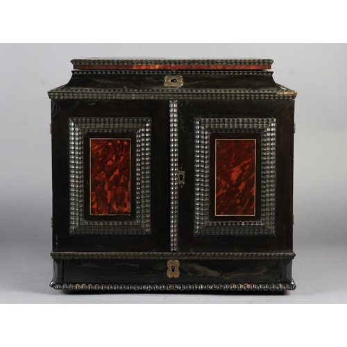 65 - A FLEMISH EBONY VENEERED TABLE CABINET late 17th century, the hinged top above a cavetto frieze and ... 