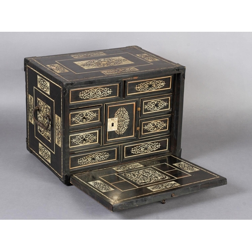 68 - AN EARLY 17TH CENTURY GERMAN EBONY VENEERED AND IVORY INLAID TABLE CABINET inlaid with rectangular a... 