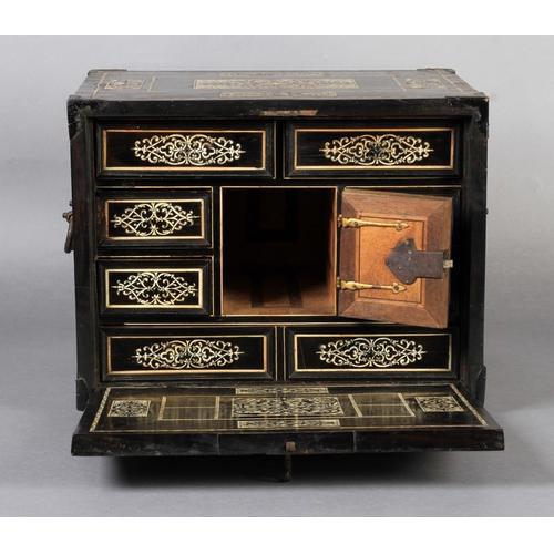 68 - AN EARLY 17TH CENTURY GERMAN EBONY VENEERED AND IVORY INLAID TABLE CABINET inlaid with rectangular a... 