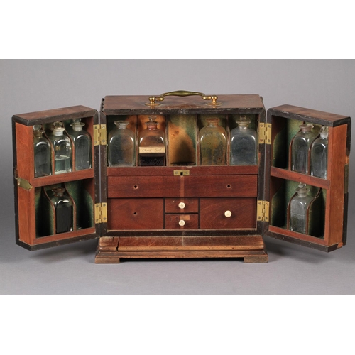 71 - A GEORGE III MAHOGANY APOTHECARY'S CABINET the divided hinged front enclosing a fitted interior of d... 