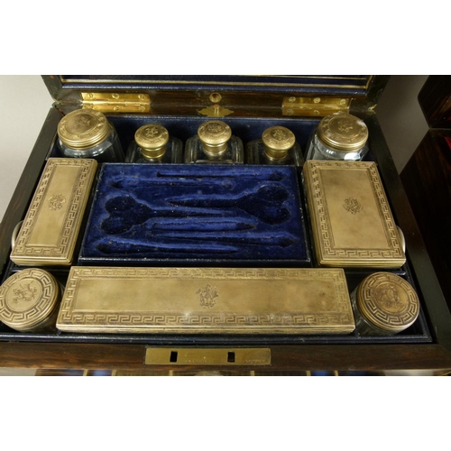 72 - A MID 19TH CENTURY COROMANDEL AND BRASS BOUND TOILET BOX, the interior fitted with ten silver gilt l... 