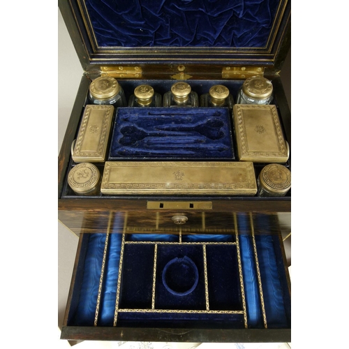 72 - A MID 19TH CENTURY COROMANDEL AND BRASS BOUND TOILET BOX, the interior fitted with ten silver gilt l... 