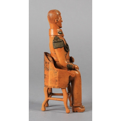 74 - A NAIVE CARVED WOODEN FIGURE OF A SEATED MILITARY GENTLEMAN, his uniform with detail of epaulettes, ... 