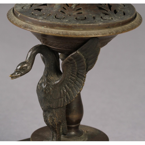 81 - A SMALL 19TH CENTURY BRONZE BRAZIER of shallow urn form on a pedestal base, the single swan mount wi... 