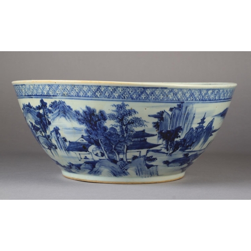 90 - A LARGE CHINESE BLUE AND WHITE BOWL 19th century painted to the exterior with a continuous pagoda an... 