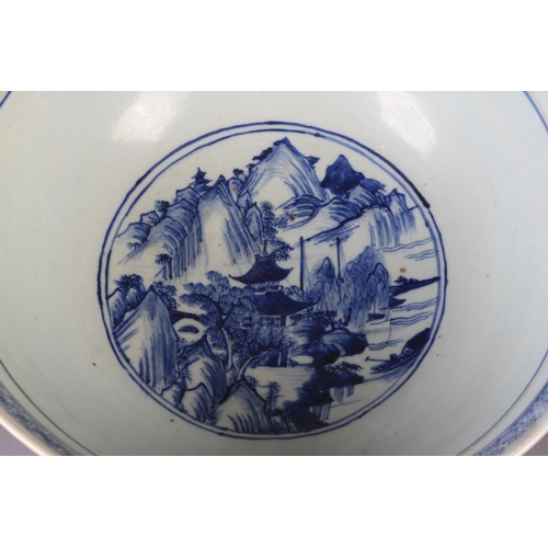 90 - A LARGE CHINESE BLUE AND WHITE BOWL 19th century painted to the exterior with a continuous pagoda an... 