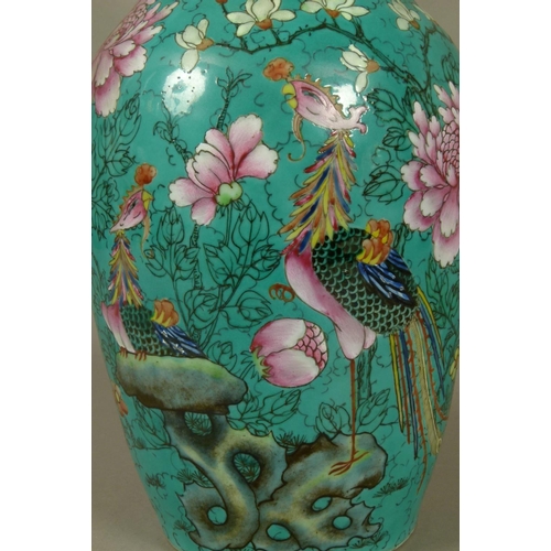 91 - A CHINESE FAMILLE VERTE VASE of baluster form, painted with exotic birds, rocks issuing magnolia and... 