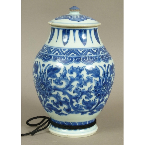 95 - A CHINESE BLUE AND WHITE BALUSTER VASE AND COVER, the body painted with flowerheads and scrolling le... 