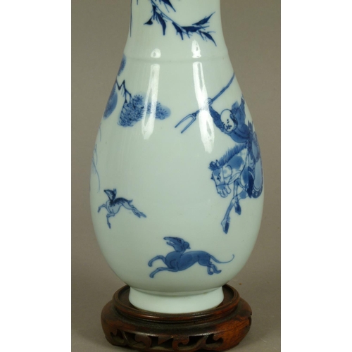 96 - A CHINESE BLUE AND WHITE BALUSTER VASE painted in underglaze blue with hunters on horseback with dog... 