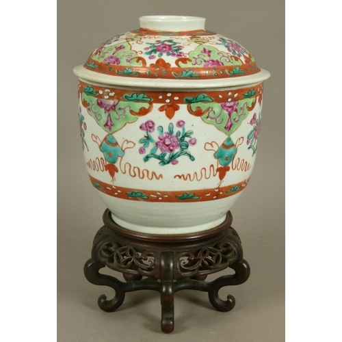 97 - A CHINESE FAMILLE ROSE DECORATED JAR AND COVER alternately painted with flowers, leafage and ribbon ... 