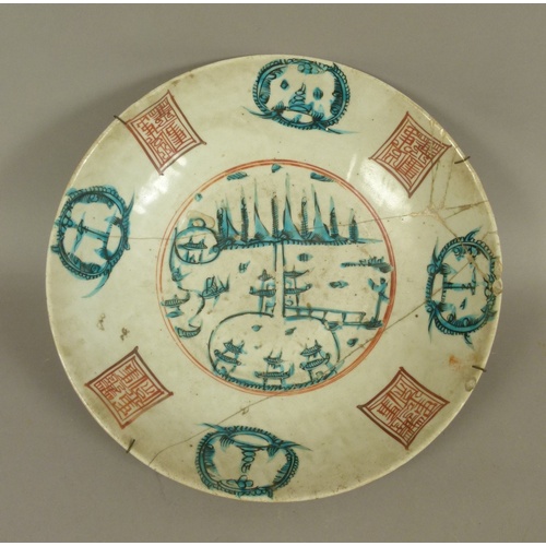 104B - A CHINESE PORCELAIN CIRCULAR CHARGER decorated to the centre in green and black with stylised temple... 