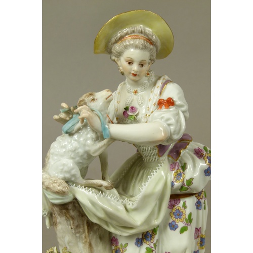 165 - A Meissen figure of a shepherdess, tying a blue ribbon around a lamb's neck, circular base with gilt... 