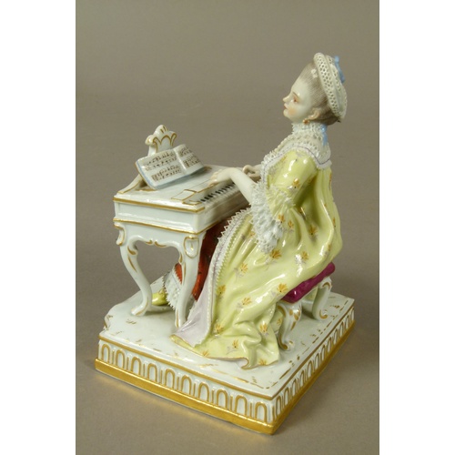 165B - A Meissen figure of a young woman playing a harpsicord, allegorical of sound, gilt detail to the bow... 