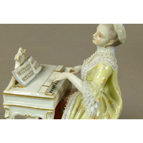 165B - A Meissen figure of a young woman playing a harpsicord, allegorical of sound, gilt detail to the bow... 