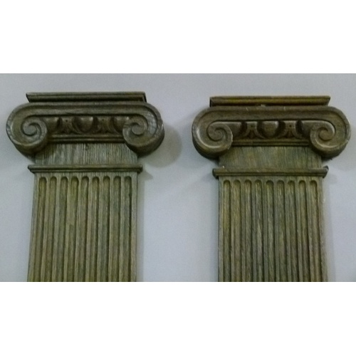 557 - A PAIR OF 17TH CENTURY STYLE OAK FLAT PILLARS with Doric capitals, fluted tapered columns, the bases... 