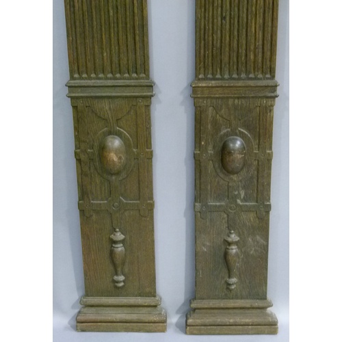 557 - A PAIR OF 17TH CENTURY STYLE OAK FLAT PILLARS with Doric capitals, fluted tapered columns, the bases... 