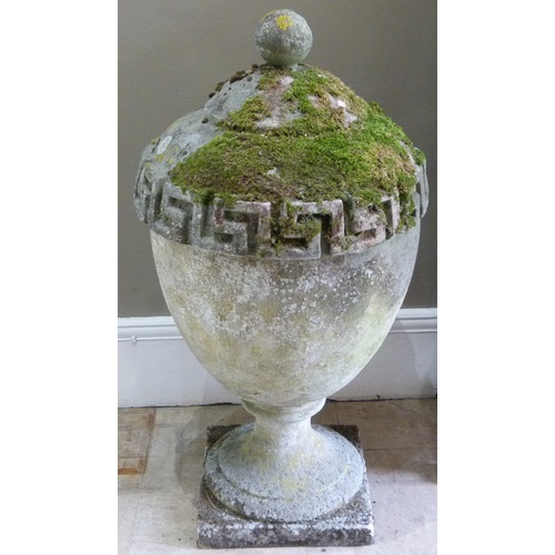 503 - A RECONSTITUTED STONE GARDEN VASE IN GEORGE III STYLE, the urnular shaped body with Greek key border... 