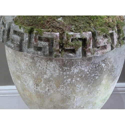 503 - A RECONSTITUTED STONE GARDEN VASE IN GEORGE III STYLE, the urnular shaped body with Greek key border... 