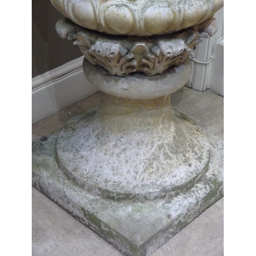 504 - A VICTORIAN STYLE CONCRETE GARDEN URN AND COVER, the body cast with pair of ram masks and oak leaf g... 