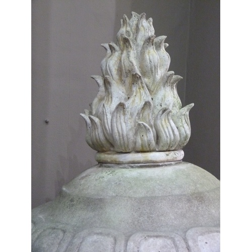 504 - A VICTORIAN STYLE CONCRETE GARDEN URN AND COVER, the body cast with pair of ram masks and oak leaf g... 