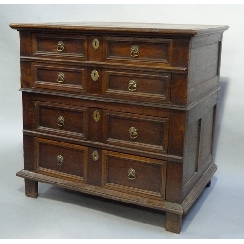 620 - A LATE 17TH CENTURY OAK CHEST of four graduated twin indented panel drawers with moulded frames, ova... 