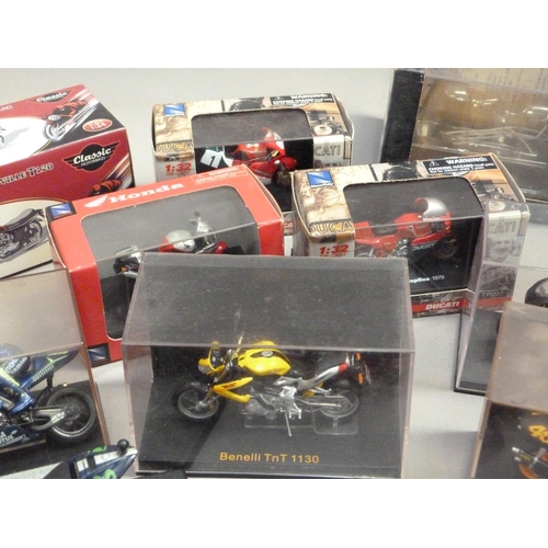 104 - A quantity of model racing bikes, 1:18 and 1:24 scale (13), together with various boxes and display ... 