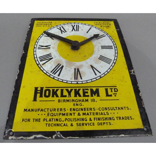 18 - An enamel advertising sign with clock for Hoklykem Ltd, 31cm x 24cm