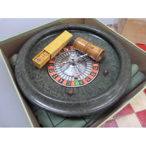 21 - A wooden chess set in original box together with a roulette wheel, dice and boxwood shaker, folding ... 