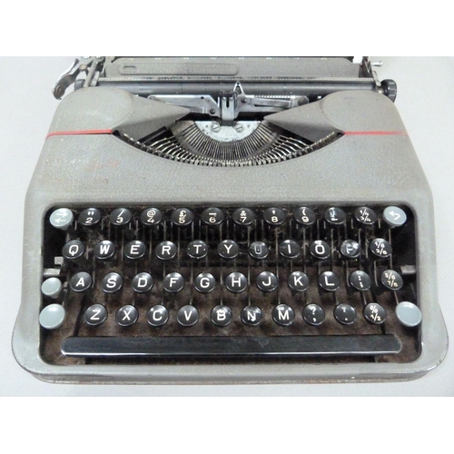 27 - A Hermes portable typewriter by Paillard in grey metal case