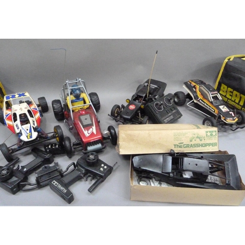 32 - Radio controlled grasshopper, hornet and two unbranded buggies, all with radio gear contained in two... 