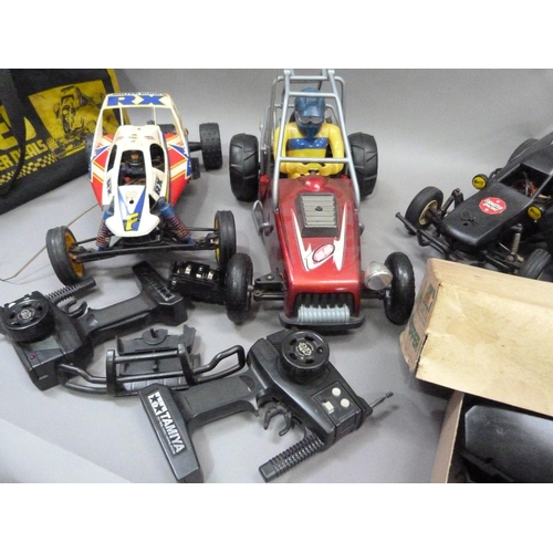 32 - Radio controlled grasshopper, hornet and two unbranded buggies, all with radio gear contained in two... 