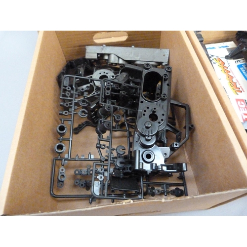 39 - A quantity of spare model parts to include plastic mouldings, chassis, etc. in four boxes (4)