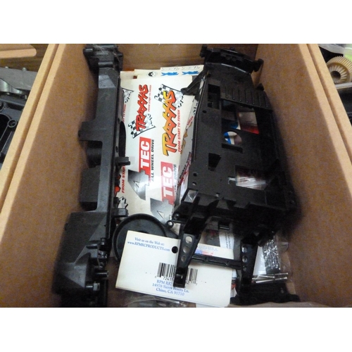 39 - A quantity of spare model parts to include plastic mouldings, chassis, etc. in four boxes (4)