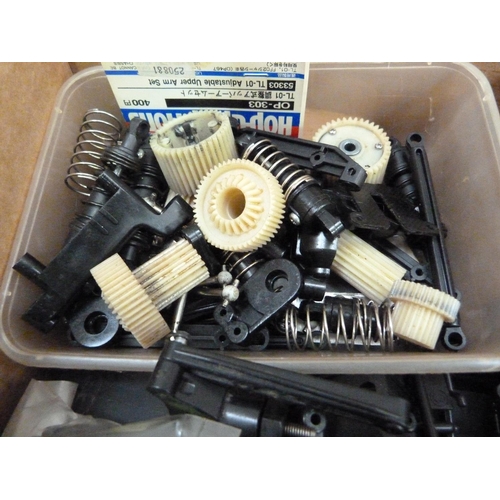 39 - A quantity of spare model parts to include plastic mouldings, chassis, etc. in four boxes (4)