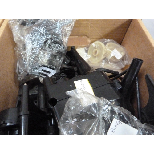 39 - A quantity of spare model parts to include plastic mouldings, chassis, etc. in four boxes (4)