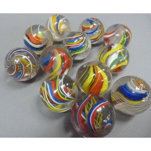 4 - A collection of twelve vintage marbles to include two with solid white core, two with yellow, red an... 