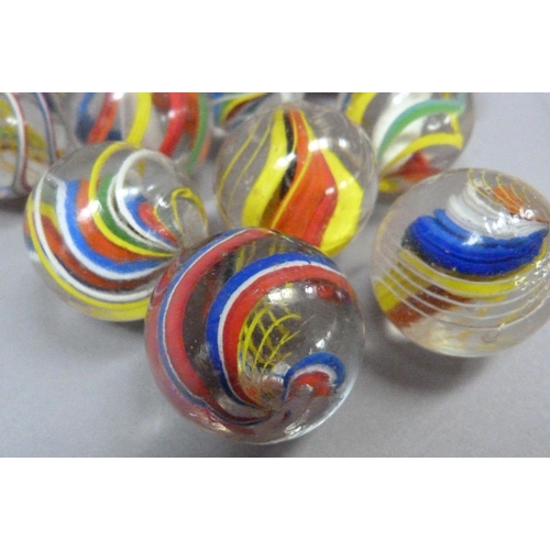 4 - A collection of twelve vintage marbles to include two with solid white core, two with yellow, red an... 