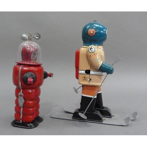 47 - South Pole Explorer B-17 skier tin plate clockwork robot, 21.5cm high, together with Moon Explorer t... 