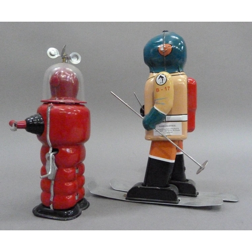 47 - South Pole Explorer B-17 skier tin plate clockwork robot, 21.5cm high, together with Moon Explorer t... 