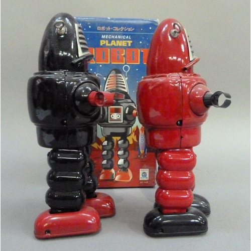 49 - Ko Toys Planet Robot tin plate clockwork robot, black, 23cm, boxed, together with another in red (no... 