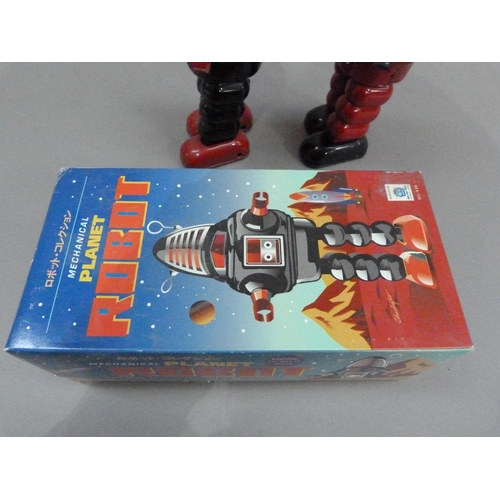 49 - Ko Toys Planet Robot tin plate clockwork robot, black, 23cm, boxed, together with another in red (no... 