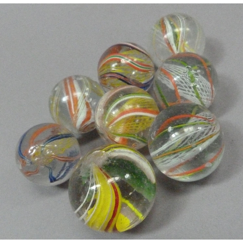 5 - A collection of eight vintage marbles, two with solid core in orange and white and in green, white, ... 