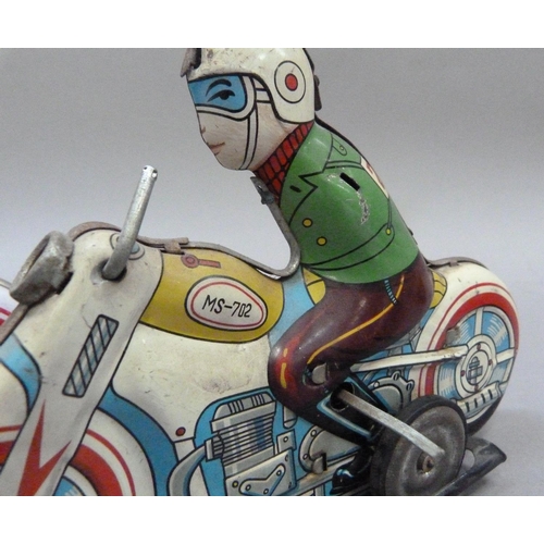 52 - A tinplate clockwork motorcyclist, c.1960s (arms missing) together with a reproduction of the same m... 