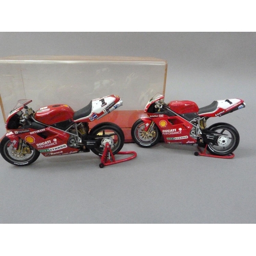 91 - Minichamps 1:12 Ducati 996 Superbike 1999 and 2000 Carl Fogarty, both boxed, together with a display... 