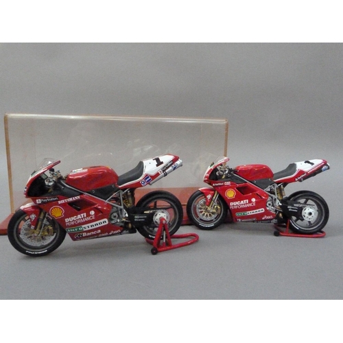 91 - Minichamps 1:12 Ducati 996 Superbike 1999 and 2000 Carl Fogarty, both boxed, together with a display... 