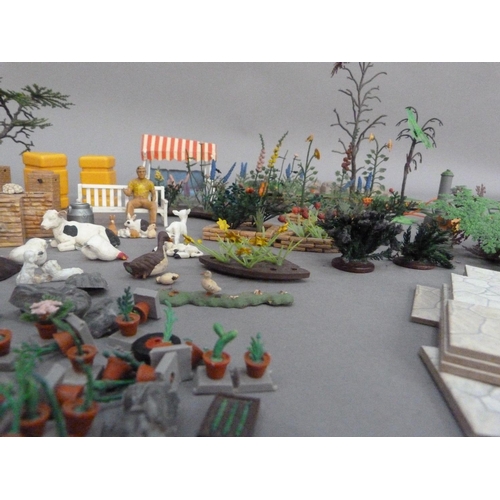 115 - A Britains plastic model toy garden with hedgerows, shrubs and plants, greenhouse, flowerberds, rock... 