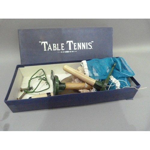 195 - A vintage Table Tennis set containing two bats, one ball, one net and a pair of posts with table cla... 