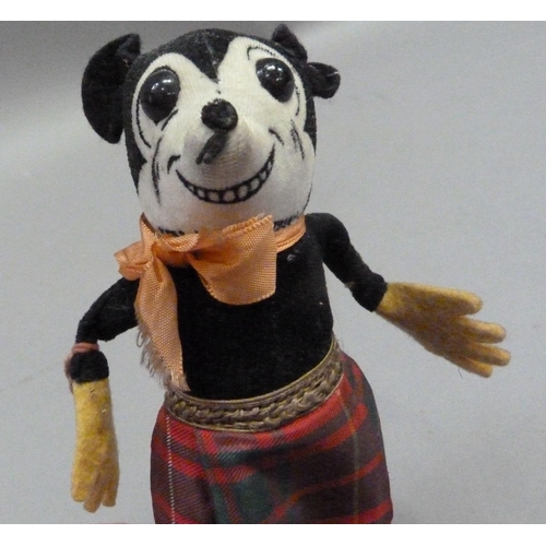 201 - A Deans Rag Book model of Minnie Mouse in a Scottish tartan skirt, reg. no. to neck, 17cm long