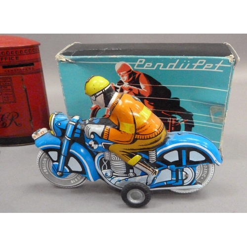 203 - A Zetor tinplate tractor and trailer, a PenduPet tinplate motorcyclist in original box, a Chad Valle... 